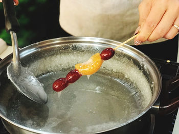 Midsection of person preparing food in kitchen