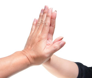 Close-up of hands over white background