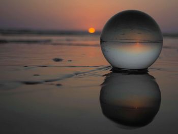 Close-up of sea against sky during sunset