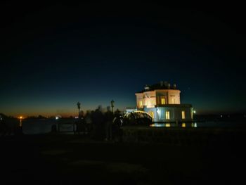 Illuminated building against sky at night