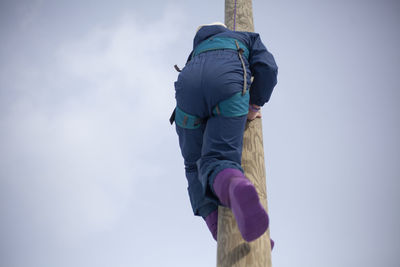 Rear view of man in snow against sky