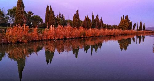 Reflection of trees in lake against sky during autumn