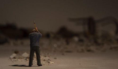 Rear view of man standing on beach