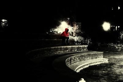 Man walking on illuminated steps at night