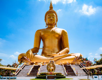 Low angle view of statue against temple against sky