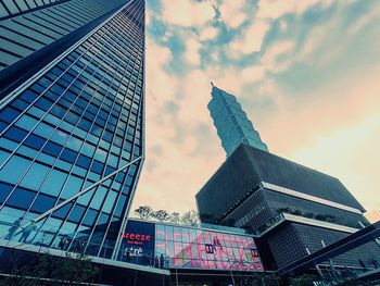 Low angle view of modern building against cloudy sky