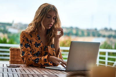 Young woman using laptop on table