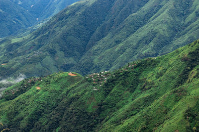 Mountain range downhill peak with light mist at morning from top angle