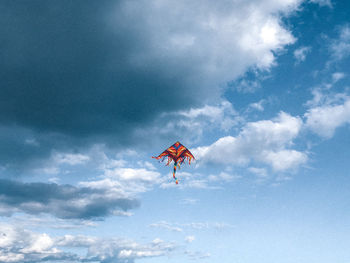 Low angle view of kite flying against sky