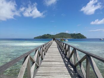 Pier over sea against sky