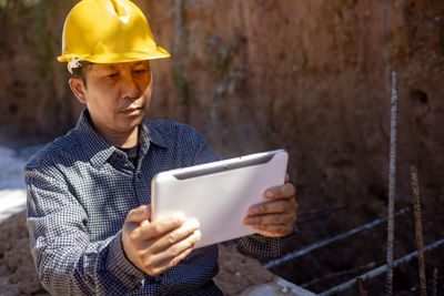 Low angle view of man working at construction site