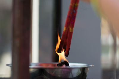Close-up of igniting incenses