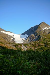 Scenic view of mountains against clear blue sky