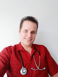 Portrait of smiling man standing against white background