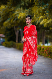 Portrait of smiling young woman standing outdoors