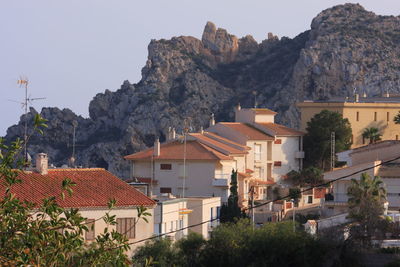 Houses in town against clear sky