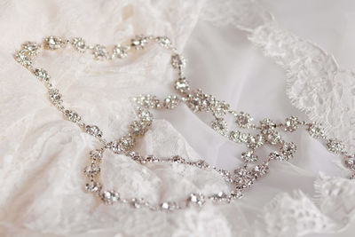 Close-up of necklace on wedding dress