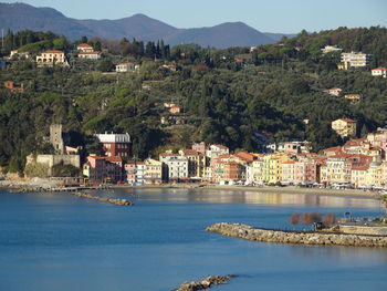 Scenic view of town by sea