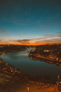 High angle view of illuminated city against sky at sunset