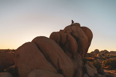 Rock formations against sky during sunset