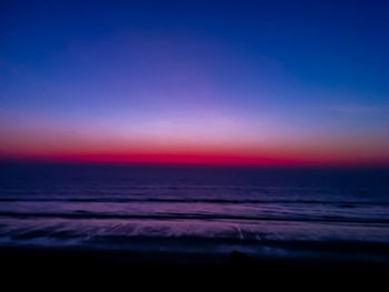 Scenic view of sea against clear sky at sunset