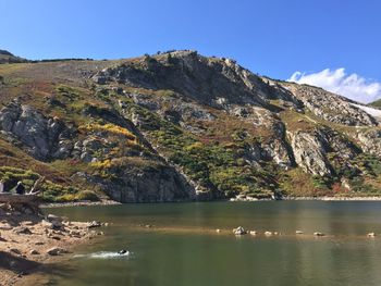 Scenic view of lake and mountains against clear sky