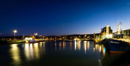 Illuminated city at waterfront