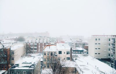 High angle view of houses in winter against sky