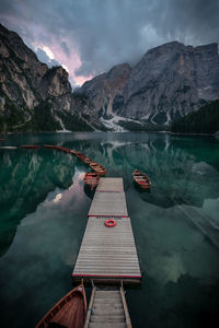 High angle view of boats moored at harbor in lake against mountains