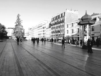 People on footpath in city