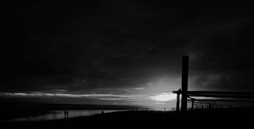 Low angle view of silhouette built structure against sky