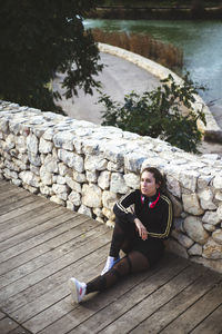 Portrait of woman sitting on wood