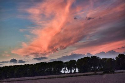 Scenic view of dramatic sky over silhouette landscape