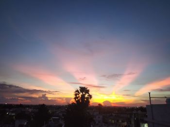 Silhouette buildings against sky during sunset