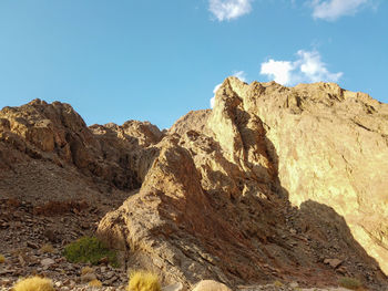 Low angle view of rock formations against sky