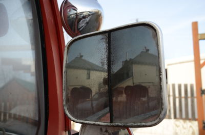 Reflection of building on car side-view mirror