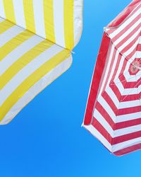 Low angle view of flag against clear blue sky