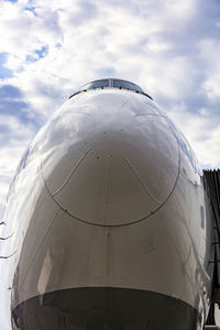 Cockpit of jet airplane against blue cloudy skies