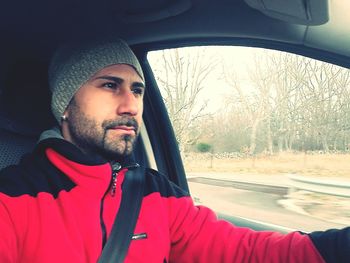 Portrait of young man in car