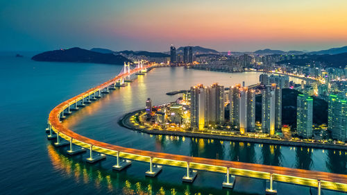 High angle view of illuminated bridge over river in city