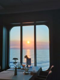 Layed table against sunset through cruise ship window