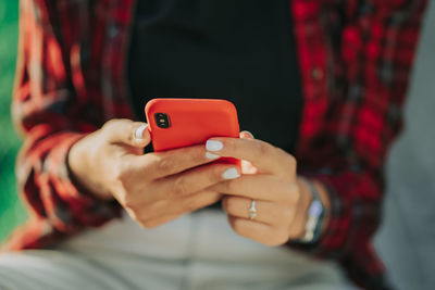 Midsection of man using mobile phone