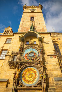 Low angle view of clock tower against sky