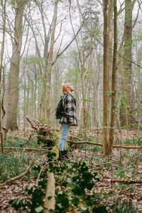 Rear view of woman walking in forest