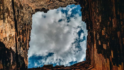 Low angle view of buildings against cloudy sky