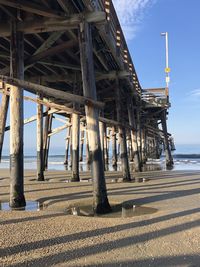 View of pier on beach against sky