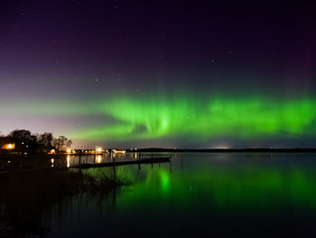 Reflection of aurora borealis on river at night