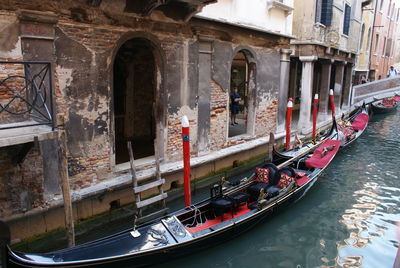 Panoramic shot of boats in canal along buildings