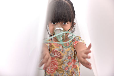 Portrait of girl wearing nebulizer