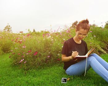 Young woman sitting on field